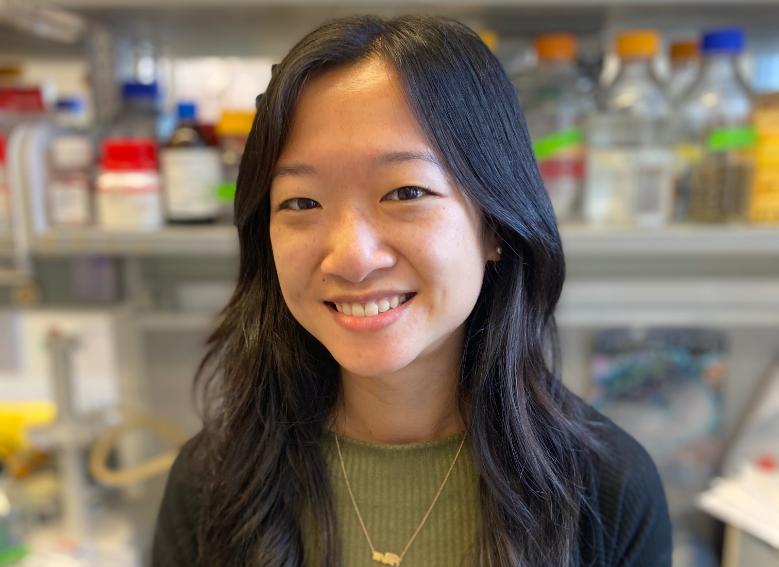 Dr Josephine Wu, smiling in her lab in Trinity. She is wearing a green top and a gold necklace.
