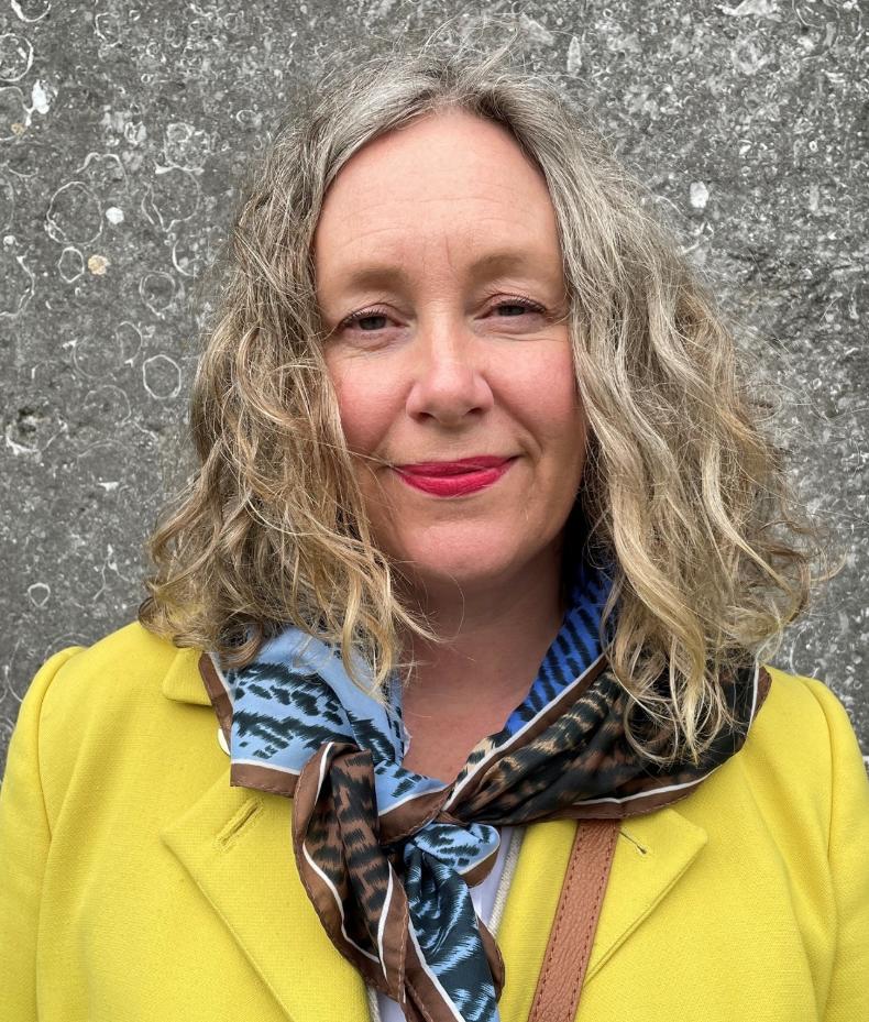 Jennifere McElwain, wearing a yellow jacket and a blue scarf