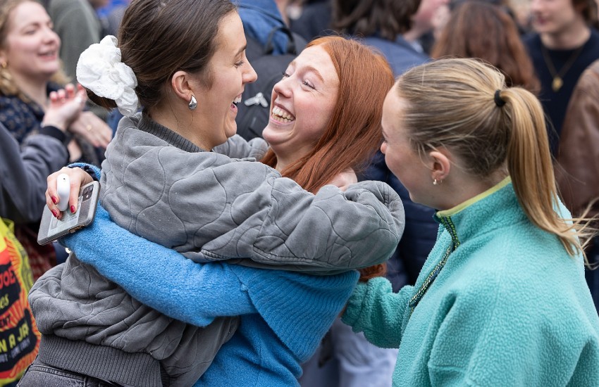 New Scholar embraced by friends