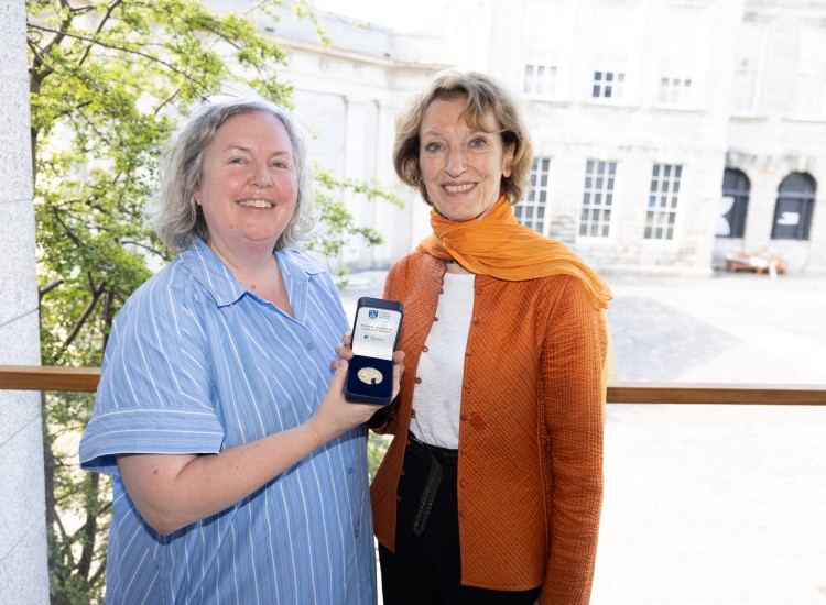 Two women with a medal