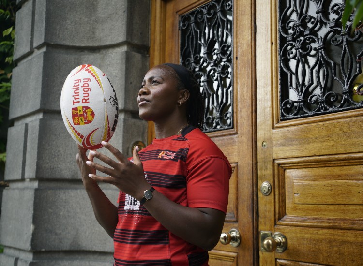 Woman balances rugby ball