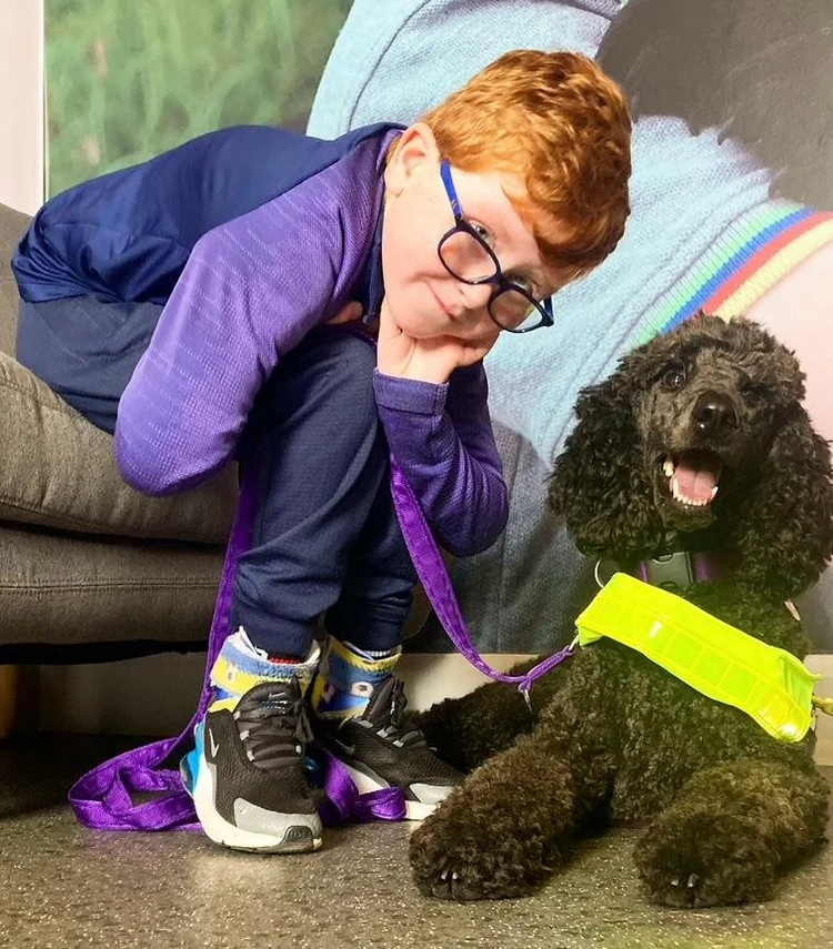 Louis Geary with his assistance dog, Maisie, who is a six-year-old black poodle pup. Image credit: Marisa Geary.