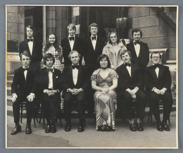 Black and white image of a group of people formally dressed