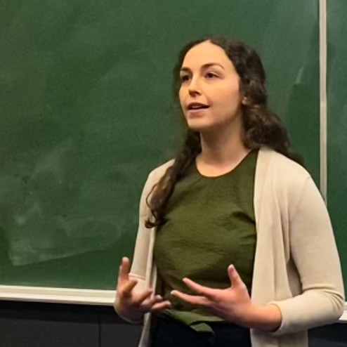 Young woman speaking in a classroom