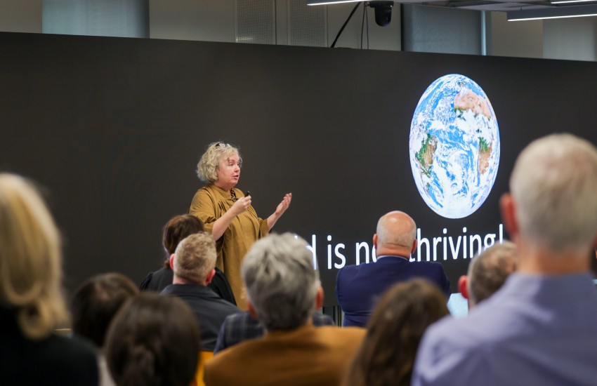 Woman presents on a podium