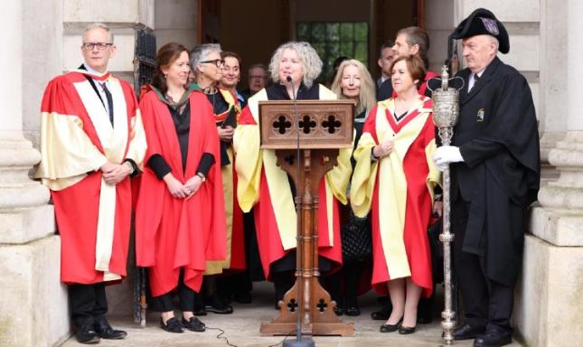Group of gowned people on steps of Public Theatre
