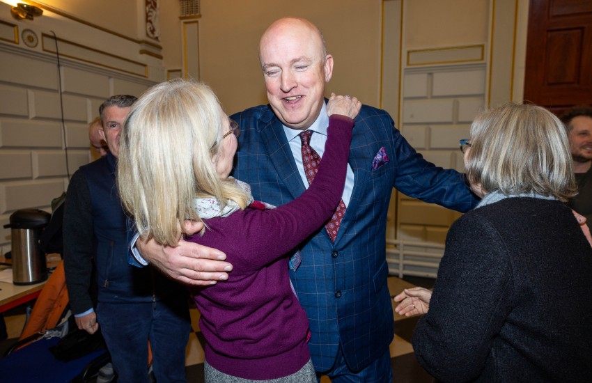 Happy man receiving a congratulatory hug