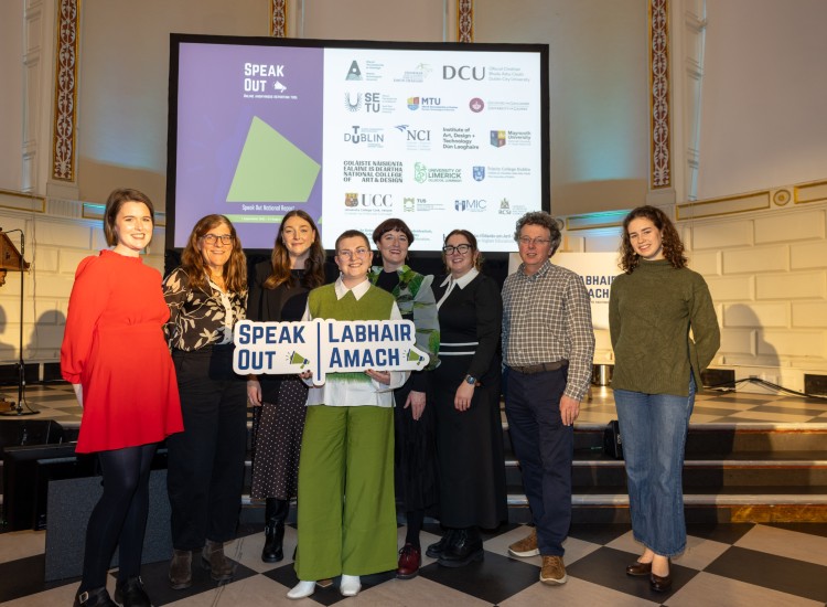group of people pose in front of podium