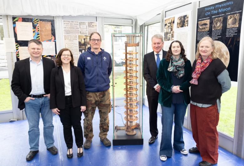Christopher Smith, Senior Experimental Officer, with Professors Louise Bradley and Jonathan Coleman, and alums, Prof. Kevin Smith, Dr Sophie Murray and Dr Nora Dempsey by the particle accelerator that Ernest Walton built in Trinity.