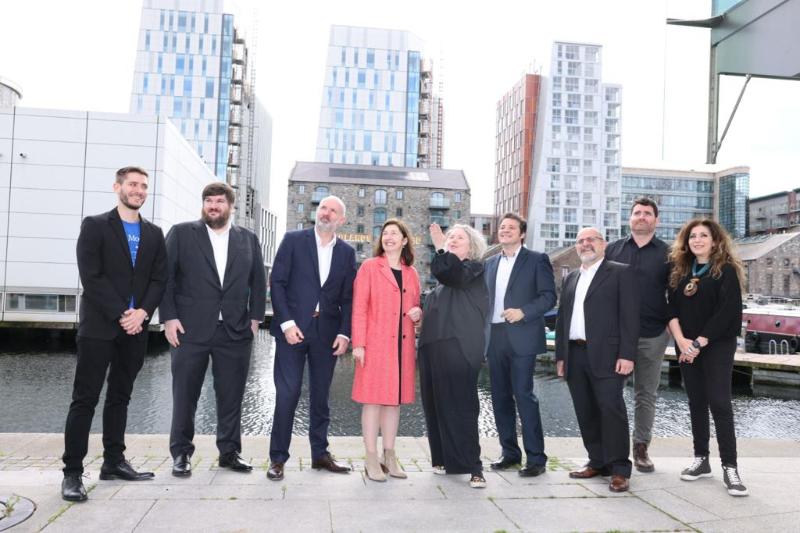 Representatives from Trinity and the five founding partners outside the customised space in Trinity East, with the water at Grand Canal Dock in the background.