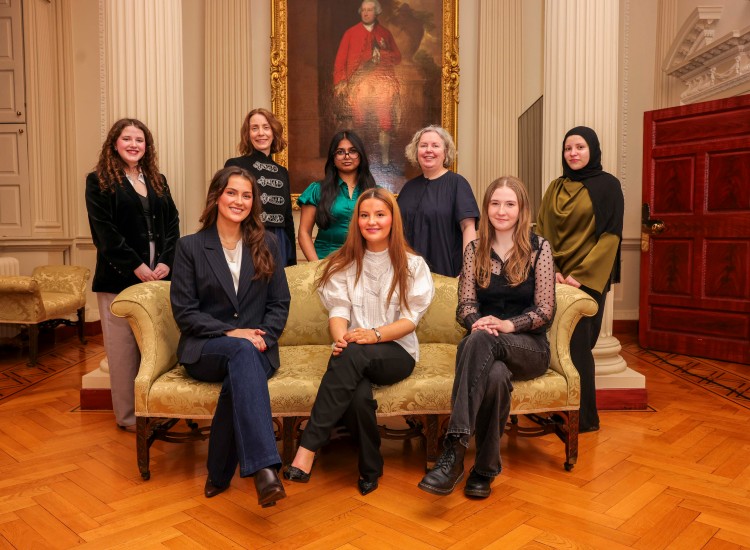 A group of women posed in formal setting