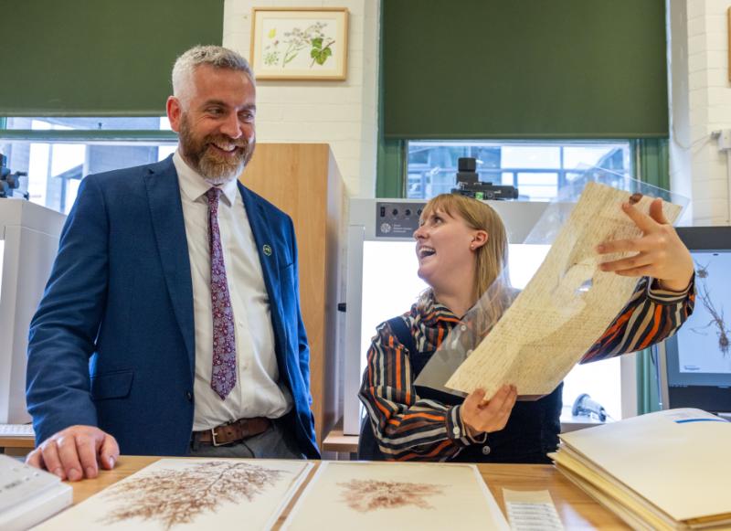 Minister Christopher O’Sullivan looks at a plant specimen in the Herbarium.