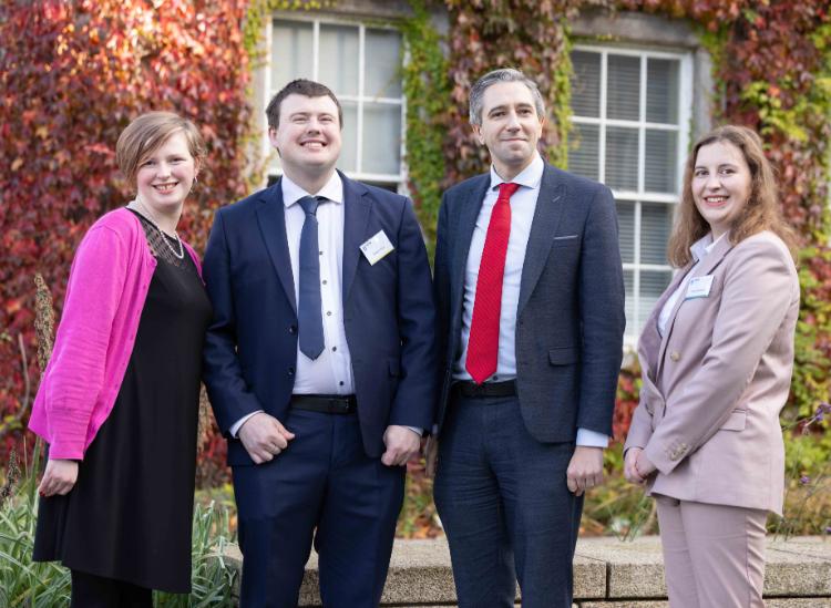 TCPID graduates with Simon Harris, outside in Trinity's grounds.