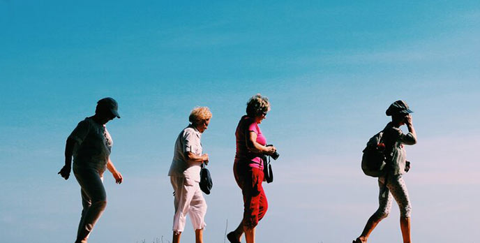 four senior female hikers