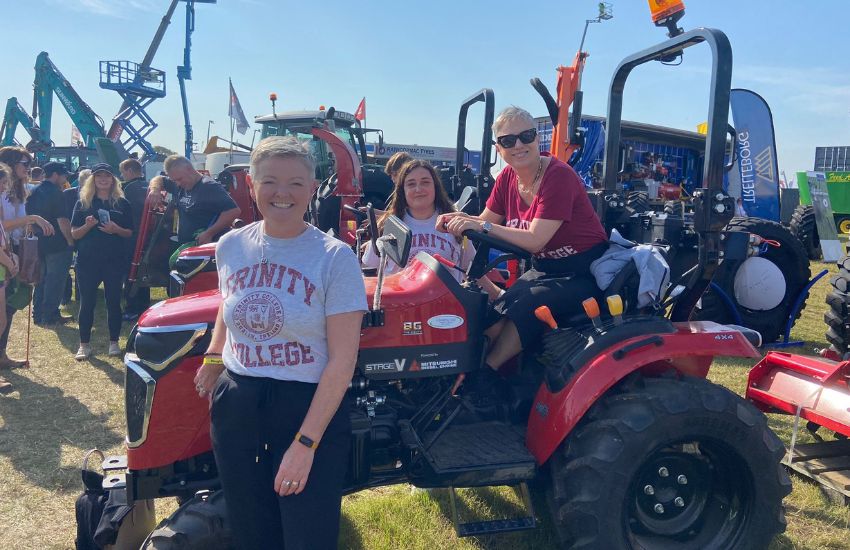 Women in Trinity T shirts on a tractor