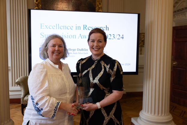 Dr Mary Hughes receives an award for excellence from the Provost