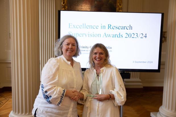 Prof Catherine Comiskey receives an award from the Provost