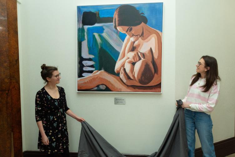 Students unveil painting of a mother breastfeeding her child