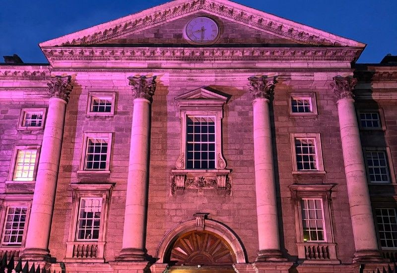 Trinity College Dublin lit-up at night in magenta