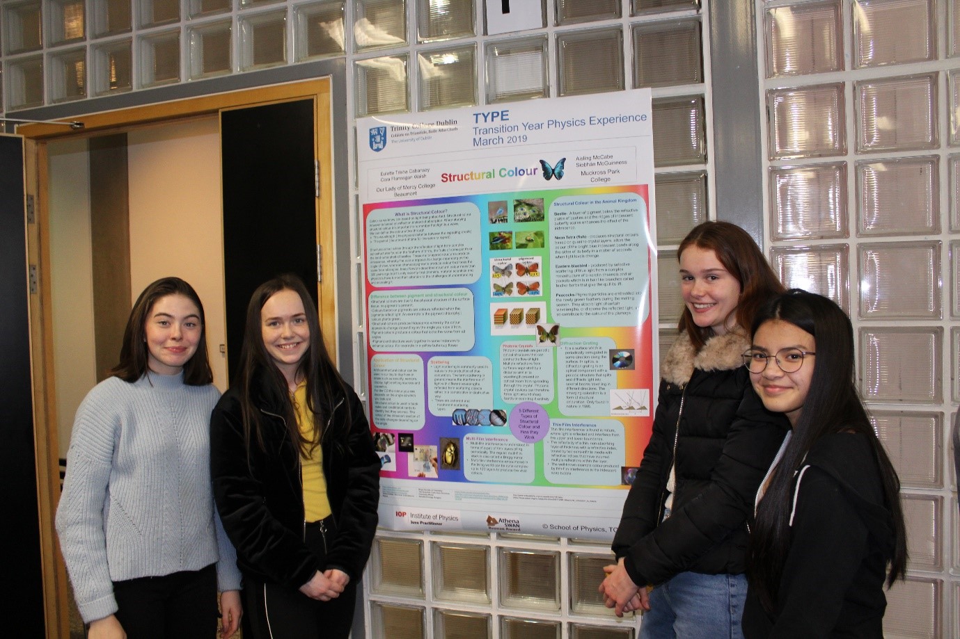 Students standing beside a poster who won the 2019 prize for best content went to Structural Colour