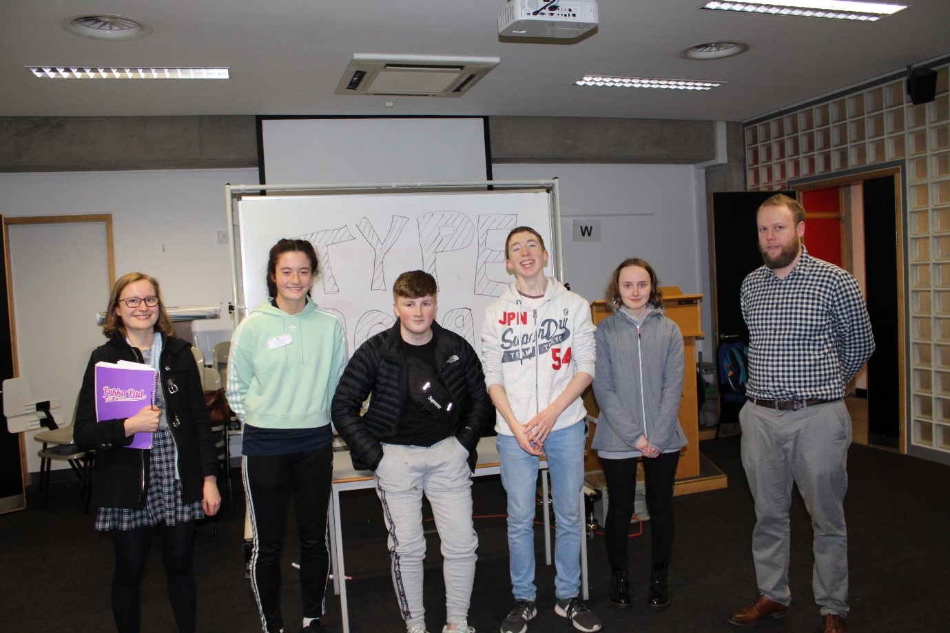 Students standing beside their poster who were runners up in the TYPE best design category