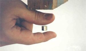Image of fingers holding a magnet