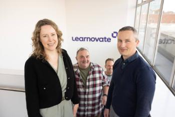 Group of people from the Learnovate team standing in front of the Learnovate sign