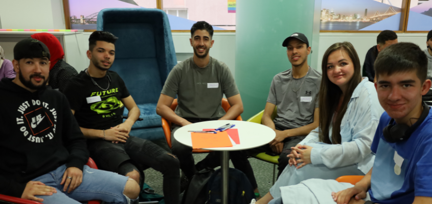 Six learners sitting together in the Global Room during the English conversation classes.
