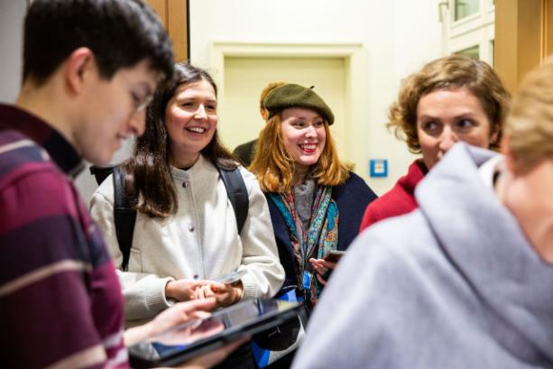 Image of a group of people at an event. They are all smiling.