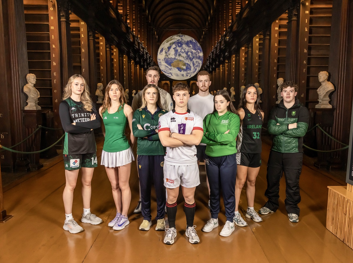 Trinity Sport Scholarship 25-26 photoshoot in Old Library featuring Back row: William MacDonald Hughes (Fencing) and Ryan O'Dwyer (GAA); front row: Ava Learn (Basketball), Sarah Hawkshaw (Tennis), Georgina Dempsey (Cricket), Oscar Cawley (Rugby), Gemma Whelan (Deaf swimming), Hazel Finn (Basketball), and Ethan Bouchard (Alpine skii).