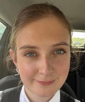 Student with brown hair smiling