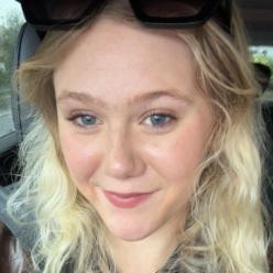 Student with blonde hair smiling