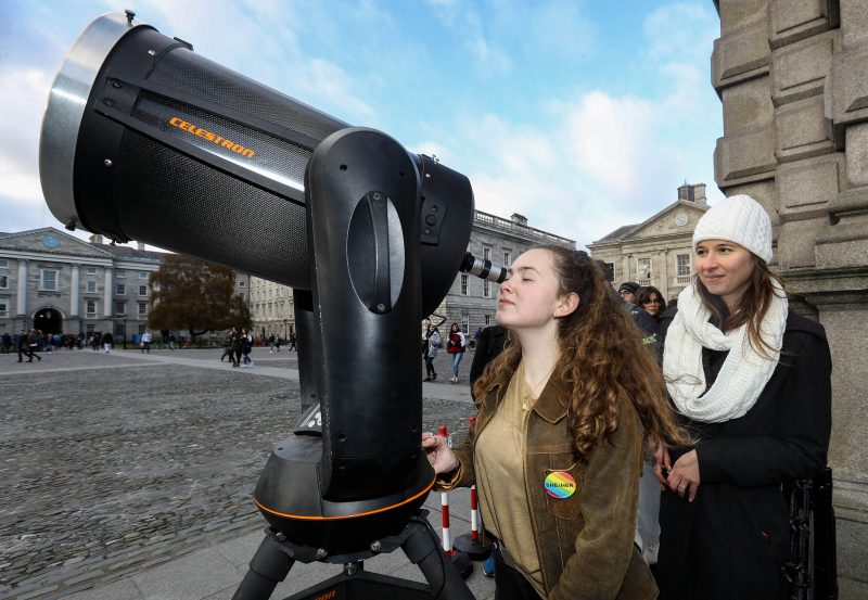 Professor Aline Vidotto looks on as an interested viewer enjoys the Mercury Transit.