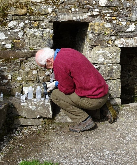 Bruce sampling from a sacred well in Co. Waterford, 2017.