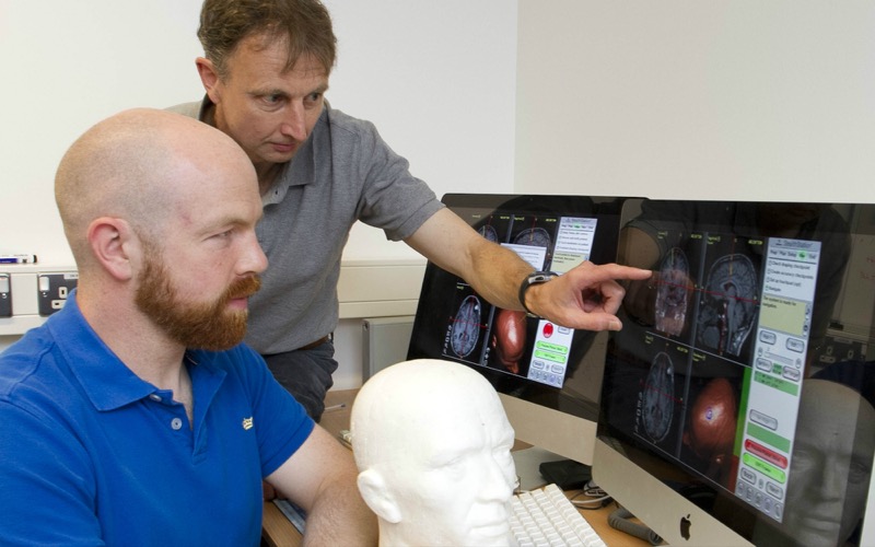 Professor Richard Carson (Trinity College Dublin’s School of Psychology) discusses brain images with a colleague after using Transcranial Magnetic Stimulation, a technique that was showcased at Discover Research Dublin