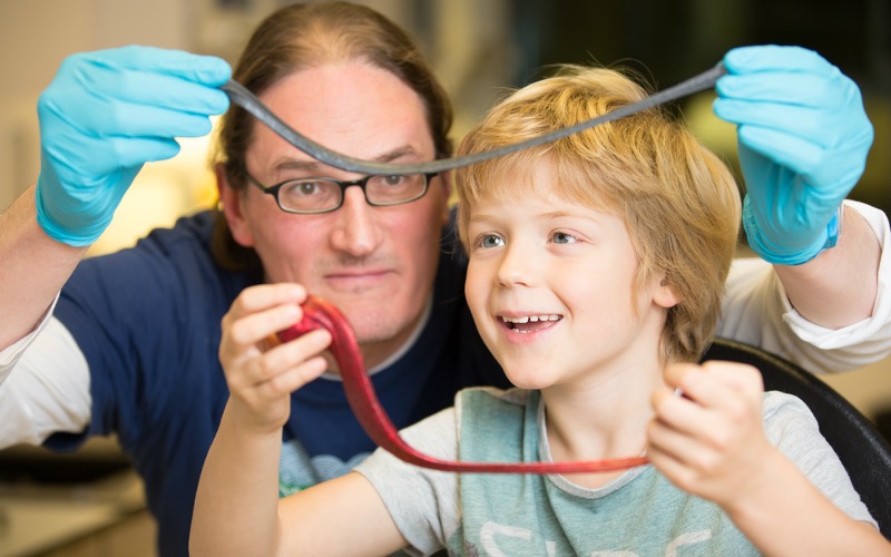 Professor Jonathan Coleman and his son, Oisin, with the amazing 'G-putty' and its playtime relative.