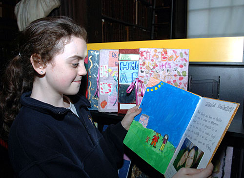 Primary school student viewing bookmarks collection at the long room in trinity college dublin 