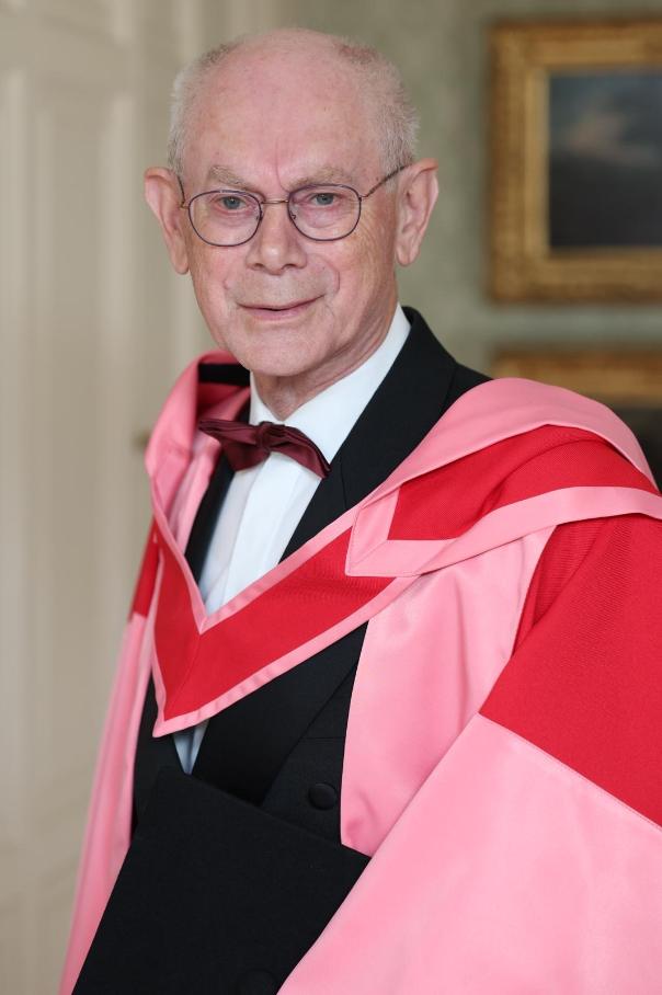 Older man poses in formal academic robes