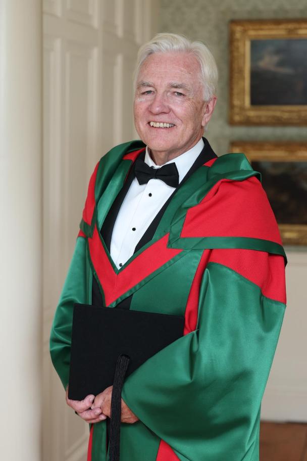 Man poses in acadmeic robes