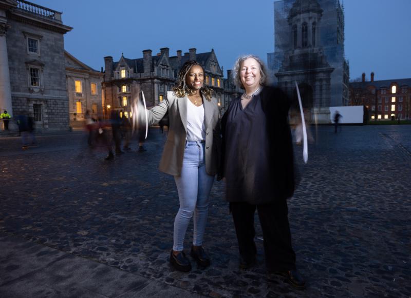 Dr Abeba Birhane and Provost Linda Doyle in Front Square on a dark night.