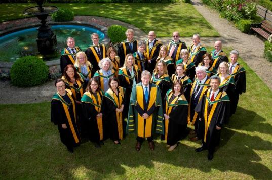 New RIA members standing in their robes