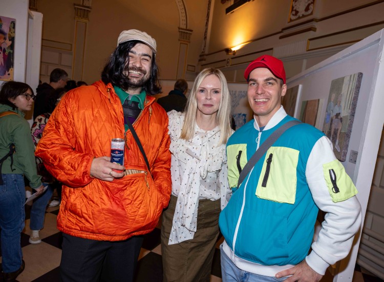 Three people, all artists,  posing