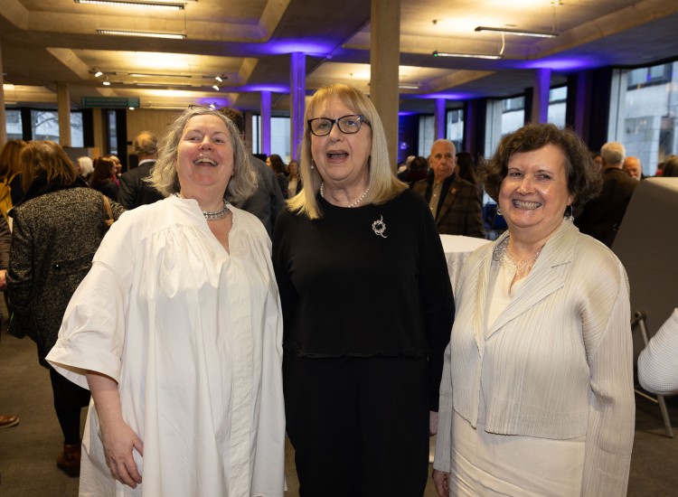 Three women pose at event