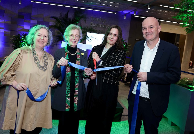 Four people cutting a ribbon