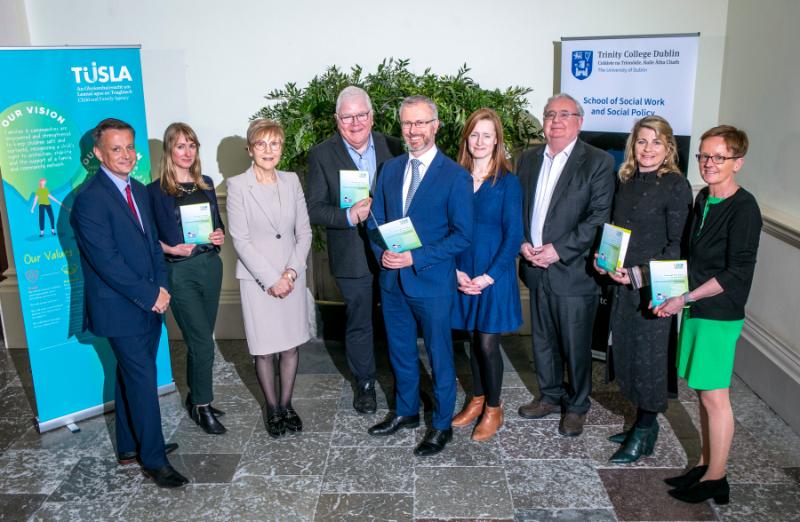 Researchers and officials pose for a picture at the launch of the report.