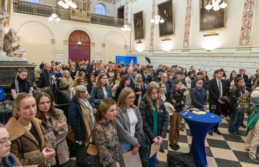 Audience stands in a large hall