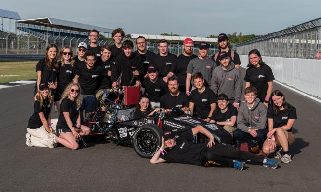 The Formula Trinity team with their car at the famous Silverstone race circuit.