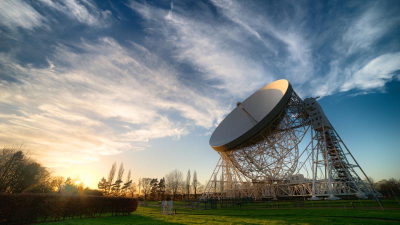 The Jodrell Lovell Telescope used by the EPTA looks up at the sky, which is blue with pale clouds. Image credit: Ant Holloway.