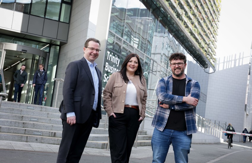 Three adult learners outside the business school