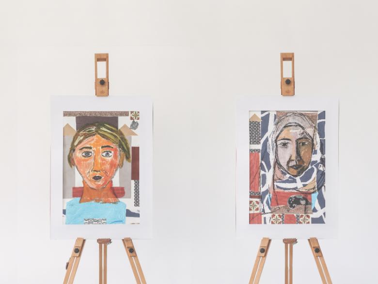 Two brightly coloured portraits on easels